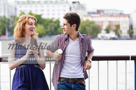 Young couple eating a lolly and an icecream