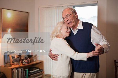 Senior couple dancing in living room