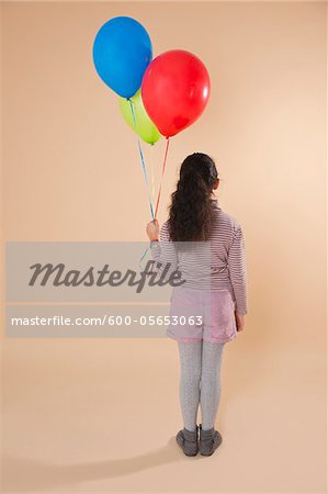 Girl Holding Balloons