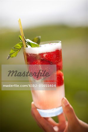 Person holding cocktail glass, clsoe-up