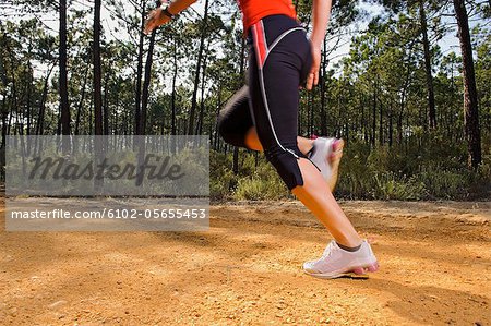 Young woman jogging, low section