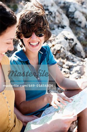 Women reading map outdoors