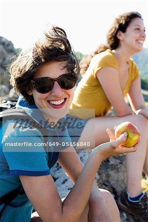Woman eating apple outdoors