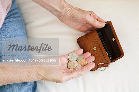 Close up of older woman counting coins