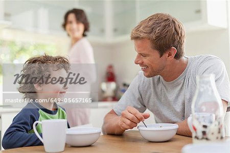 Famille manger le petit déjeuner dans la cuisine