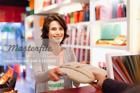 Woman buying purse in store