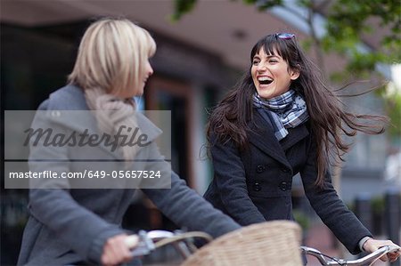 Women riding bicycles on city street