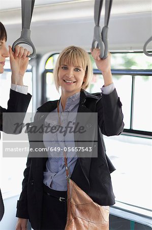 Smiling businesswomen riding the bus