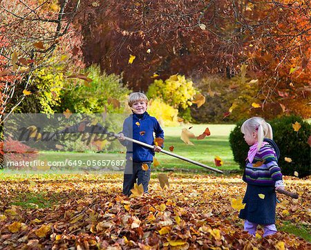 Children raking fall leaves