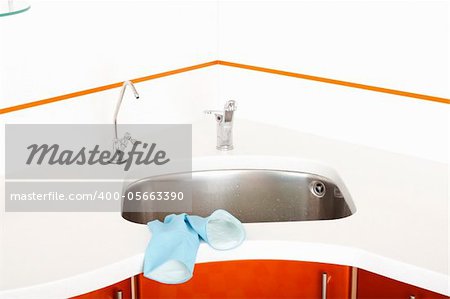 washbasin, blue rubber gloves and chrome faucets