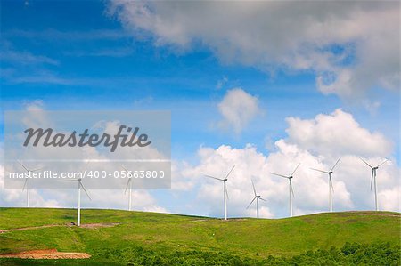 Electricity power wind generator pole against blue sky background