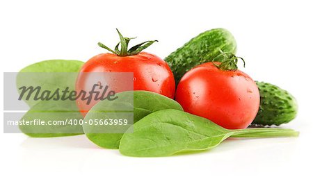 fresh tomato vegetables with cucumbers and spinach  leaves isolated on white background