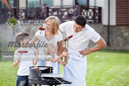 Family eating sausages in the open air