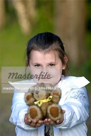 Girl giving  teddy bear