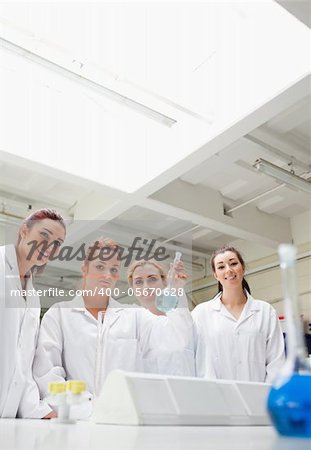 Portrait of chemistry students holding a flask while looking at the camera