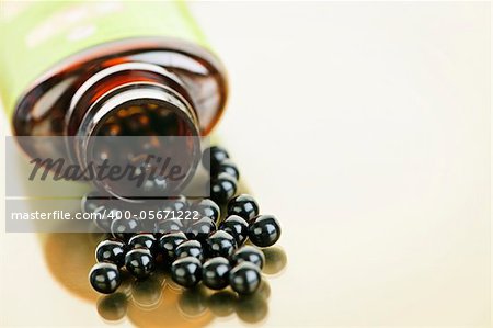 Traditional chinese herbal medicine pills spilling from bottle