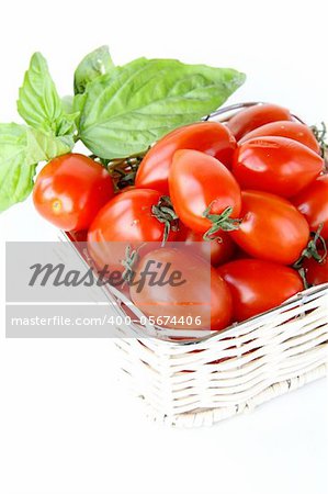 fresh cherry tomatoes and basil over white