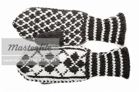 Knitted winter mittens with pattern on white background