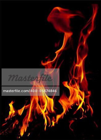 Red fire flames of a fireplace with black background