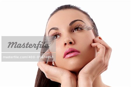 portrait of pretty and sensual brunette with hair tail and creative make up with long eyelashes with thinking pose