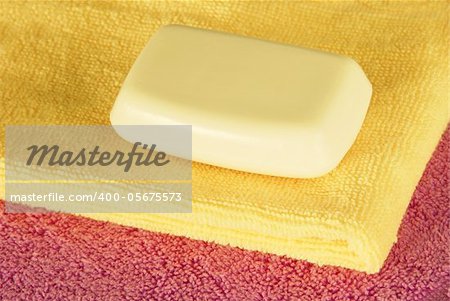 magenta and yellow towels with white soap bar