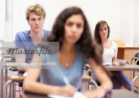 Serious students taking notes in a classroom