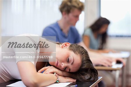 Tired student sleeping in a classroom