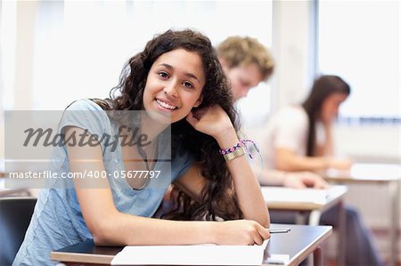 Smiling young student posing in a classroom