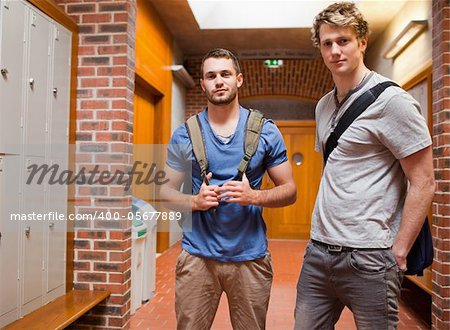 Handsome students posing in a corridor