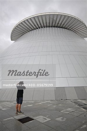 man taking photo of modern building