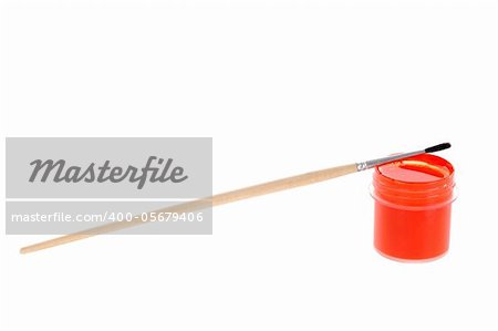 Red gouache paint and small brush isolated on white background