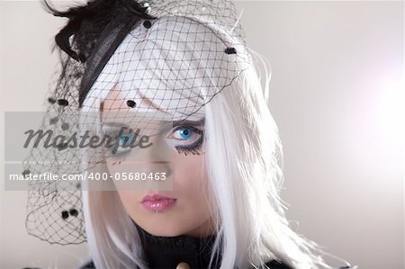 Portrait of young woman wearing blue contact lenses, studio shot