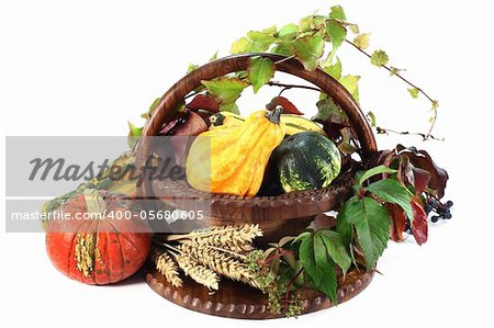 a basket decorated with ornamental gourd, wild grape and wheat ears