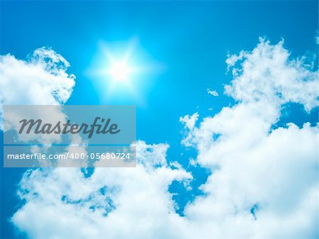 An image of a blue sky with a bright sun background