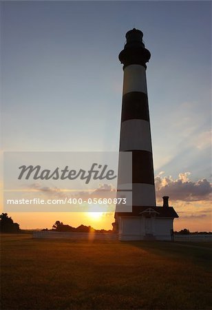 Silhouetted view of the Bodie Island lighthouse on the outer banks of North Carolina at sunrise vertical