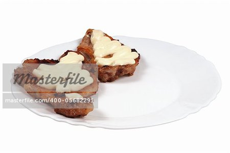 Grilled meat  with  mayonnaise  on a plate. Isolated on white.