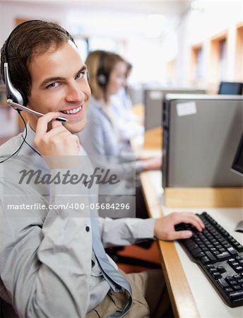 Portrait of an assistant using a headset in a call center