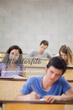 Portrait of students during a lecture with the camera focus on a model