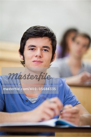 Portrait of a student listening to a lecturer in an amphitheater