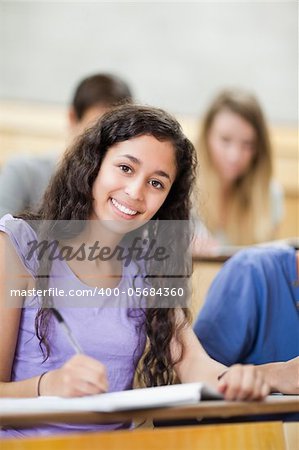 Smiling student in a amphitheater looking at the camera