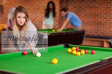 Woman playing snooker in a student home