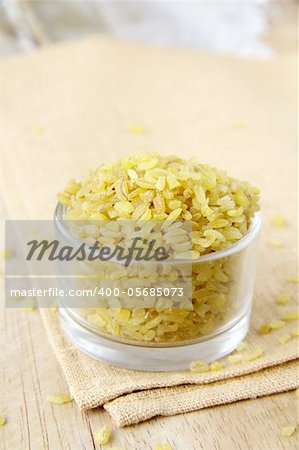 bulgur wheat in a glass bowl on a wooden table