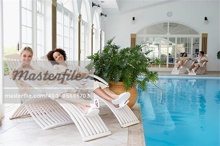 Women Relaxing Around Pool At Spa