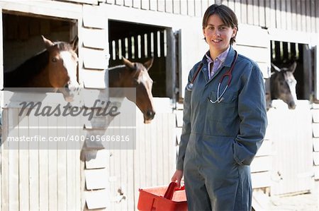 Portrait Of Vet Standing By Horse Stables