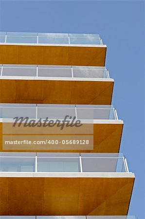 Modern building with balcony on a blue sky.