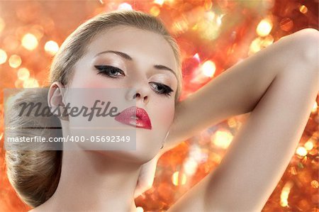 old fashion portrait of a young beautiful blond woman with hair style and deep red yellow lips on colored background