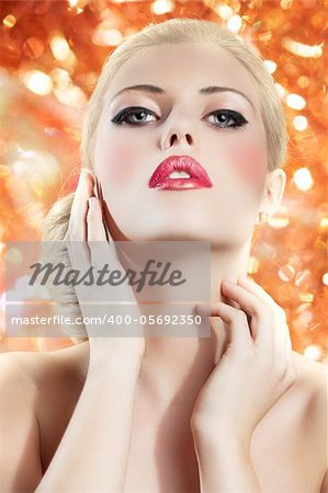 old fashion portrait of a young beautiful blond woman with hair style and deep red yellow lips on colored background