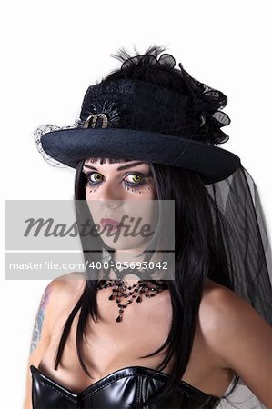 Young witch with scary yellow eyes, wearing Halloween veil hat, isolated on white background