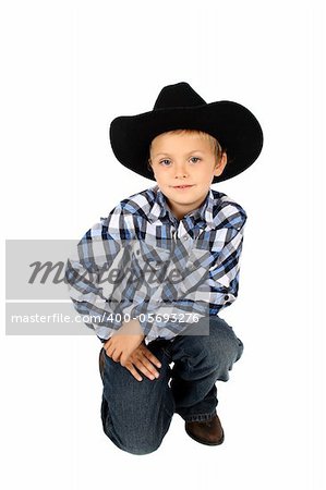 Young cowboy wearing a hat against white