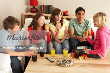 Group Of Children Eating Burgers At Home